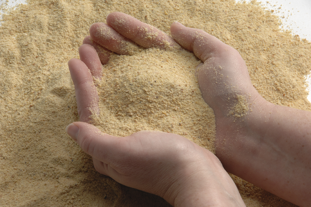 hands holding ExPress soybean meal